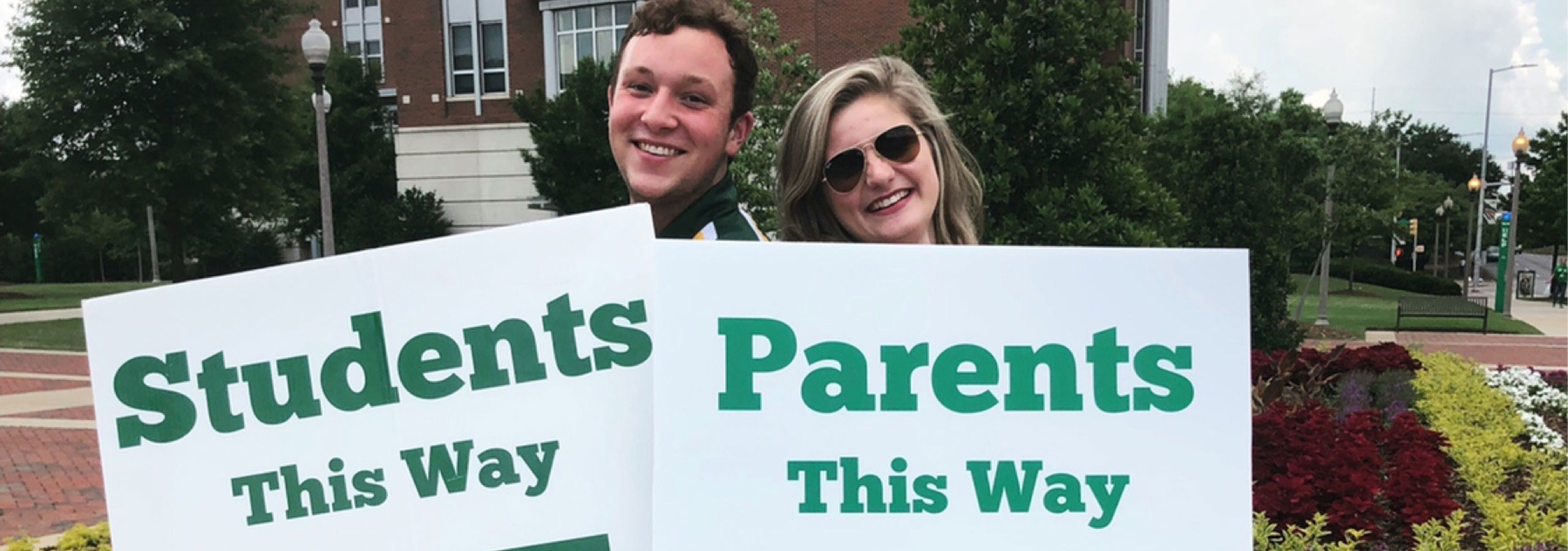 Students in front of a UAB sign.