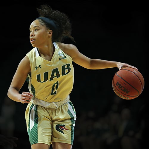 UAB basketball player scoring during game against Western Kentucky.