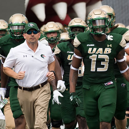 UAB basketball player scoring during game against Western Kentucky.