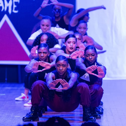 Group of female students performing.