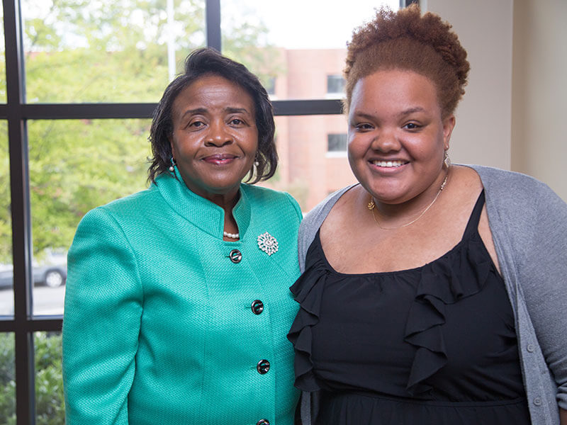 Program Director Kathryn Morgan posing with a graduate. 
