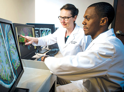 Kristina Visscher mentoring Leland Fleming in a lab. 