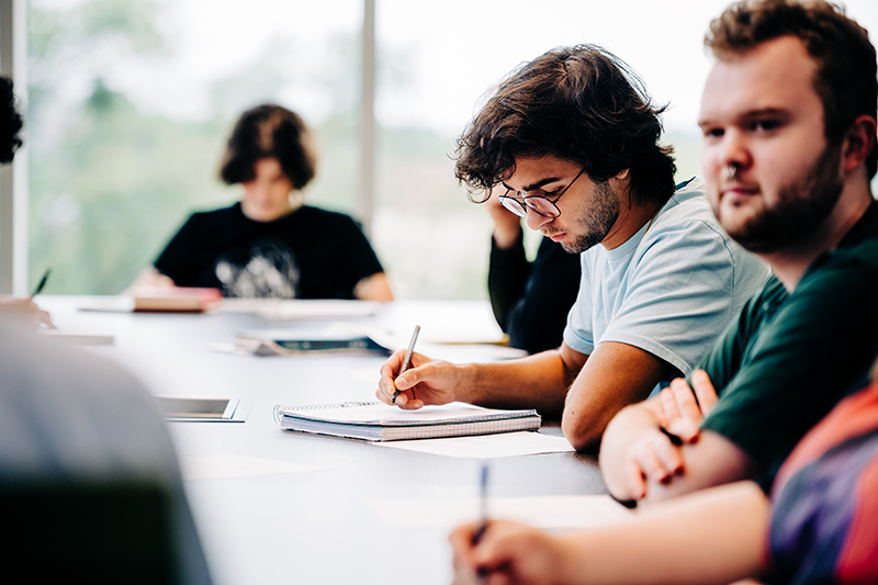 Philosophy student speaking to classmates during a class discussion.