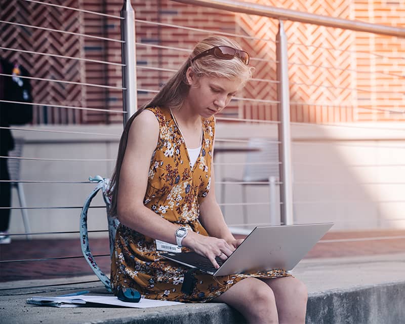 Philosophy student studying while sitting on steps.