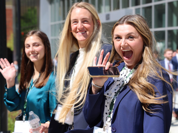 Three future dental students waving during Welcome Day