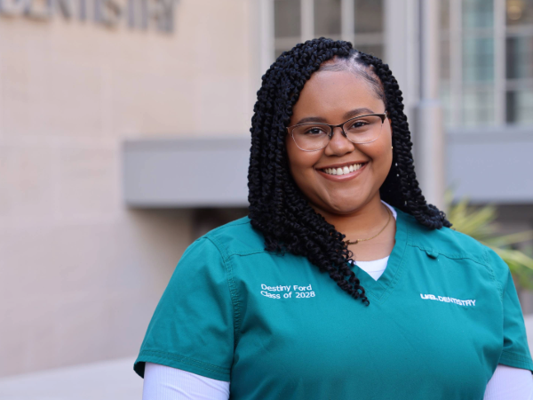 Destiny Ford standing in front of the UAB School of Dentistry