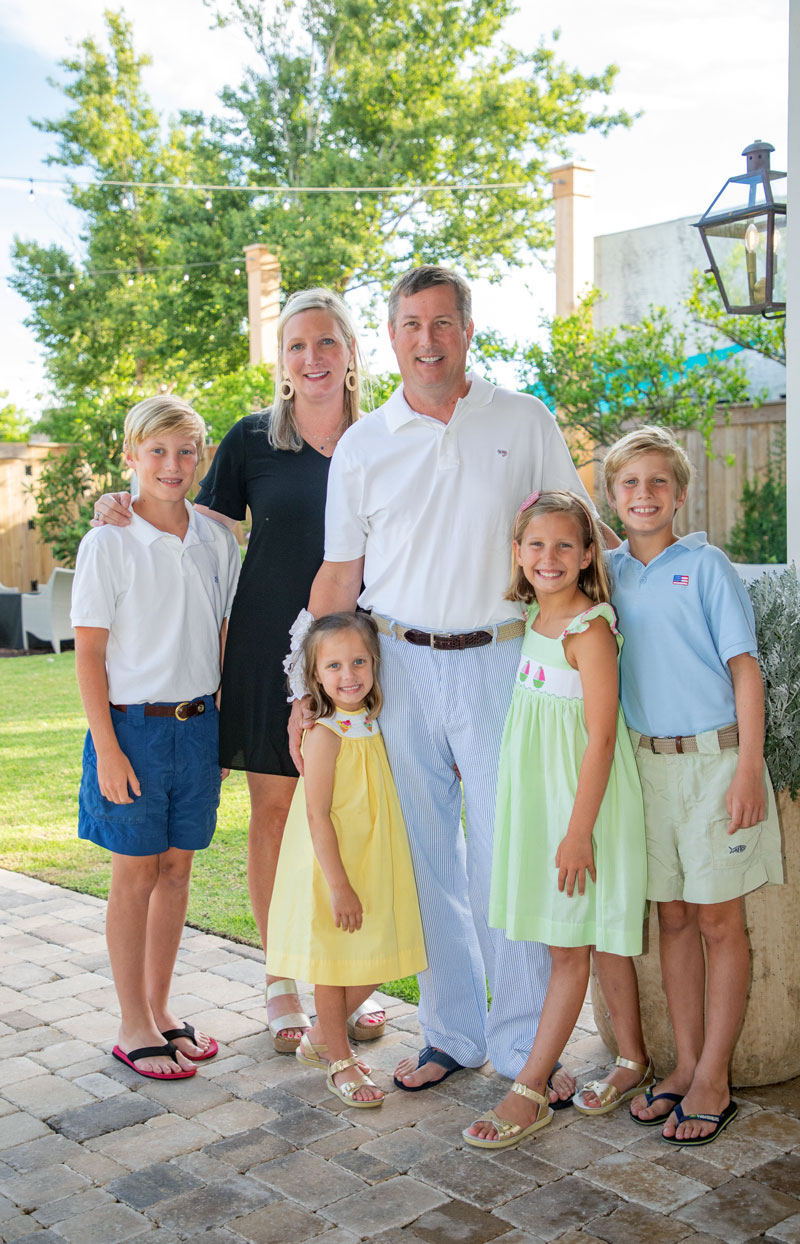 Leslie Buckley and her family standing outside,  a green tree in the background. 