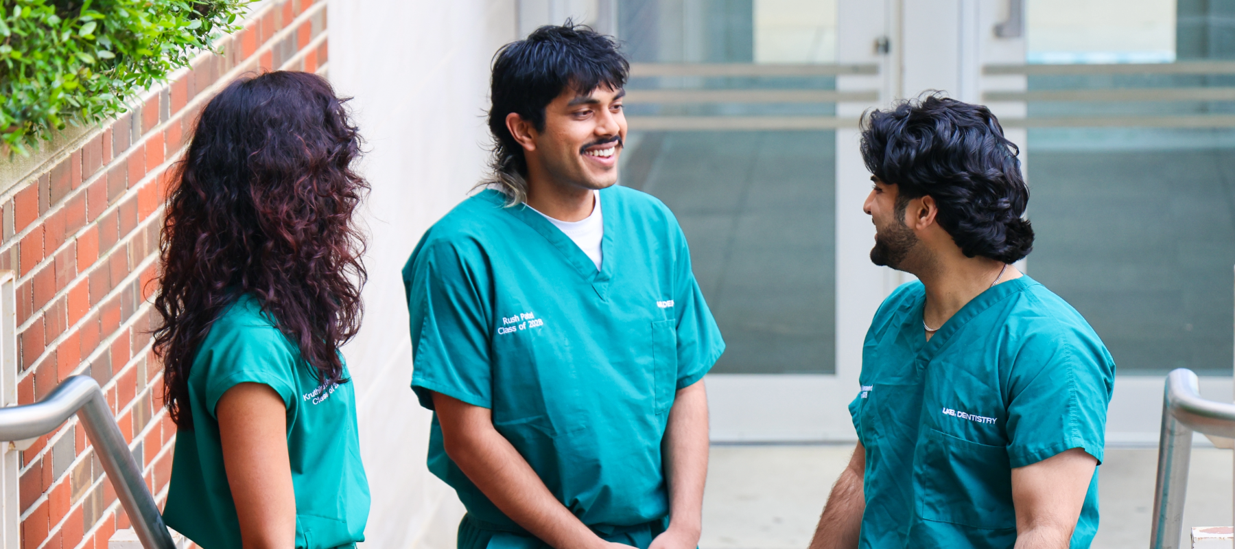 Three dental students chatting outside