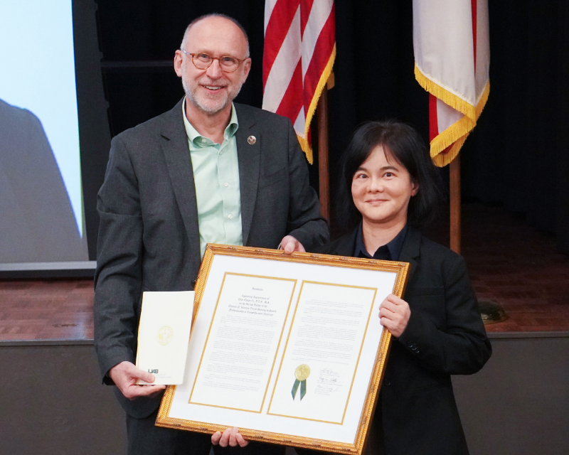 Dean Geurs presenting Dr. Fu's endowment certificate