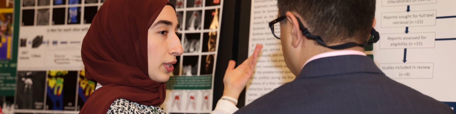 Student presenting to faculty member at Scholars Symposium 2025.