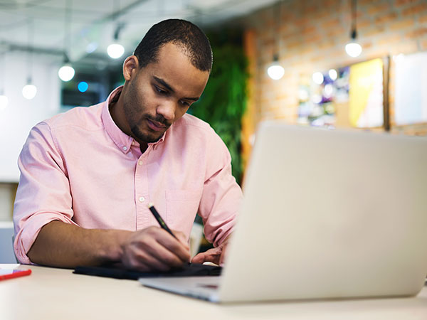 Man working at a laptop.