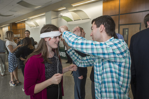 Student demonstrating his design at the UAB BME Research Symposium Poster Session. 