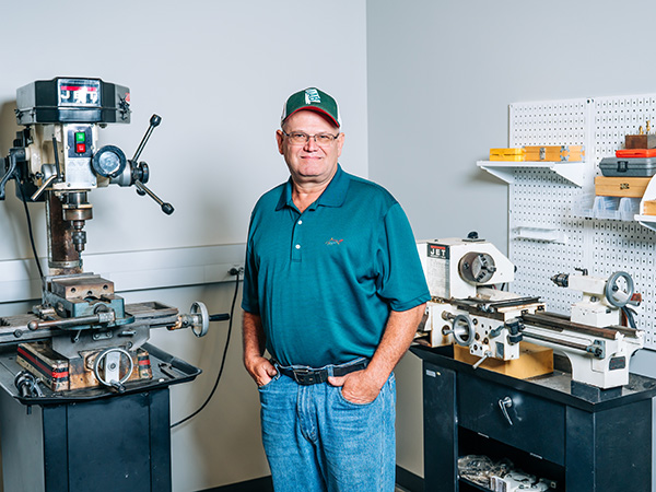 Man posing in machine shop