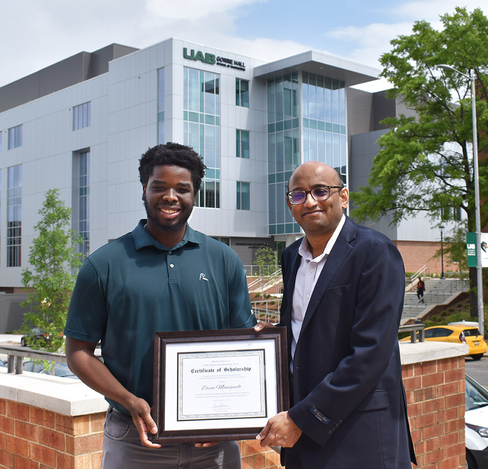 Devin Manigault, left, is presented the Jones Memorial Scholarship by CCEE Chair Avinash Unnikrishnan.