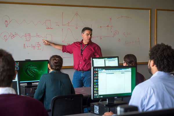 Chemistry professor teaching classroom of students.