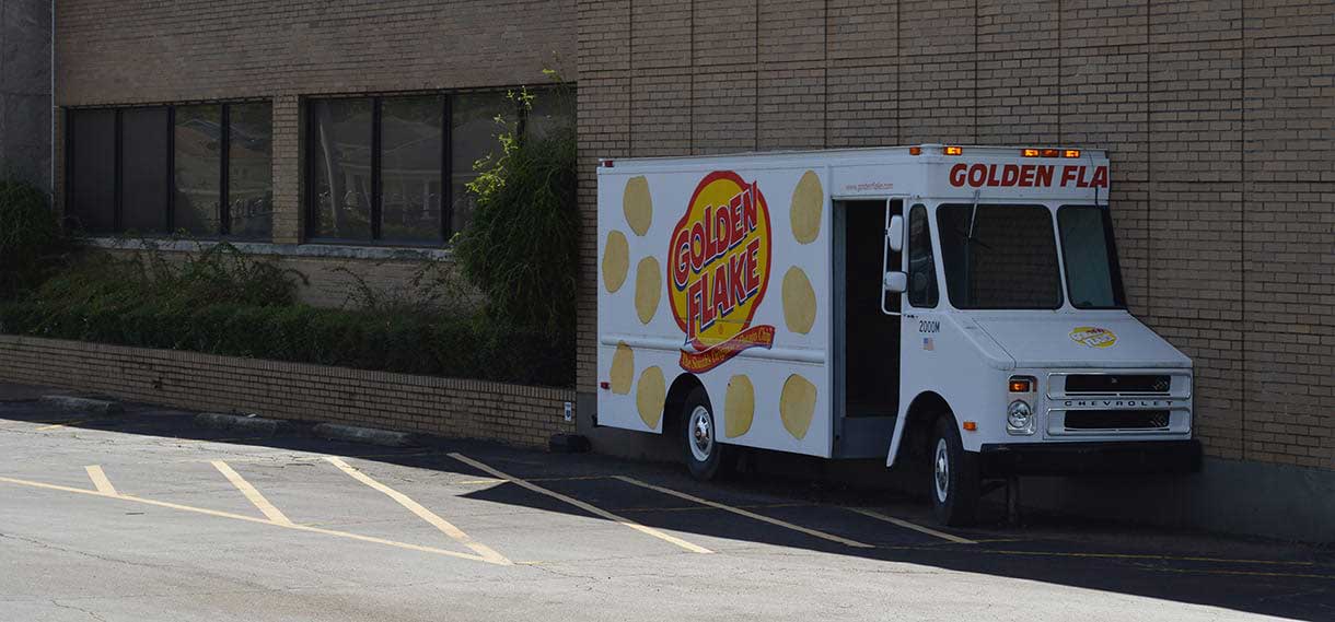 A Golden Flake delivery truck that is now a decoration embedded in a wall.