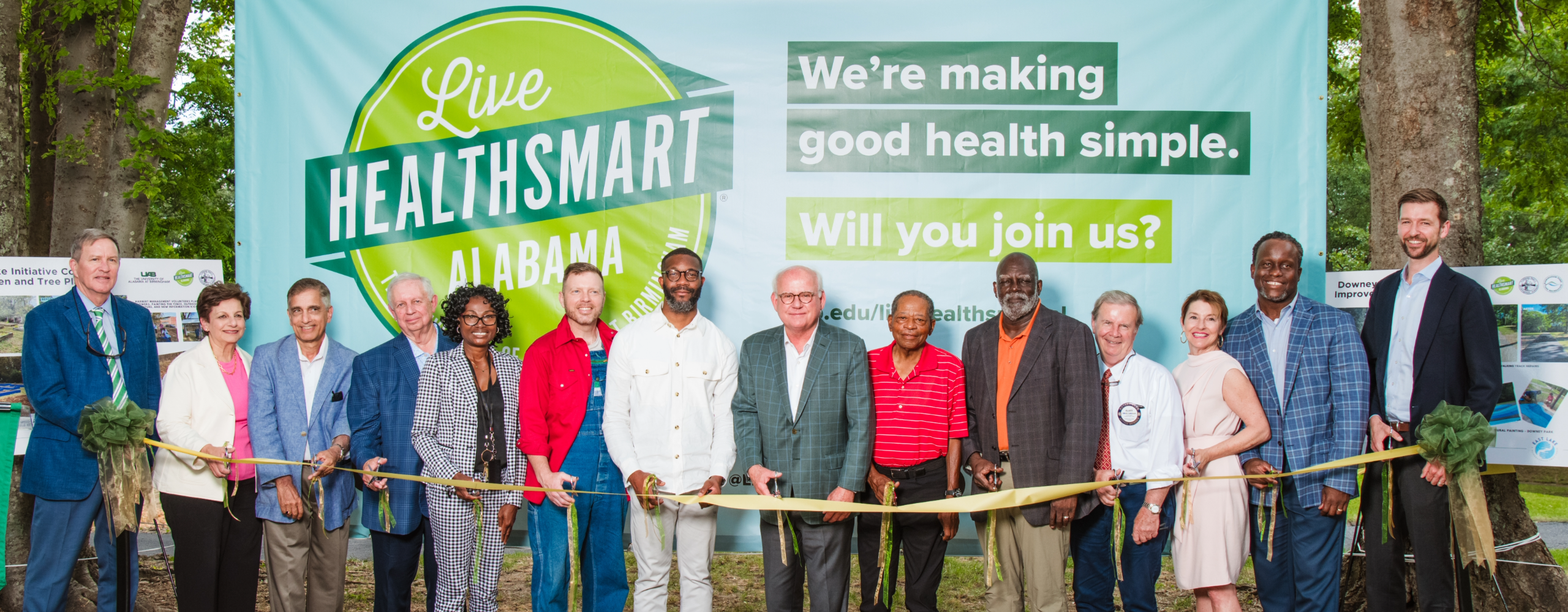 UAB President Watts, Mayor Randall Woodfin, and others pose with scissors at the Live HealthSmart ribbon cutting.