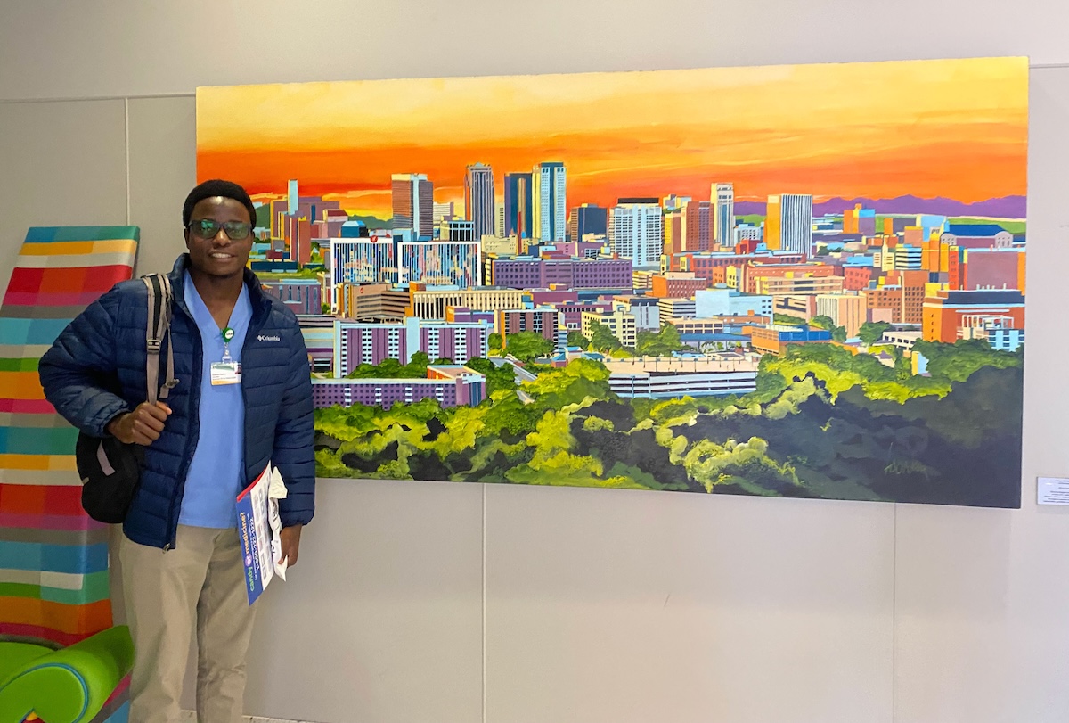 Jonathan Kajjimu in front of colorful birmingham skyline