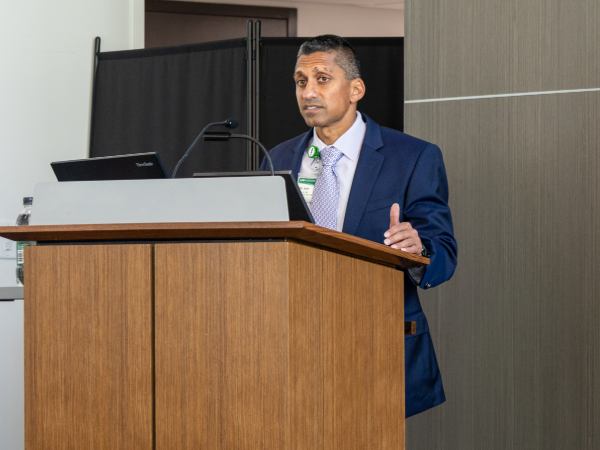 Irfan Asif, MD, addresses an audience from the podium during the state of the department presentation. 