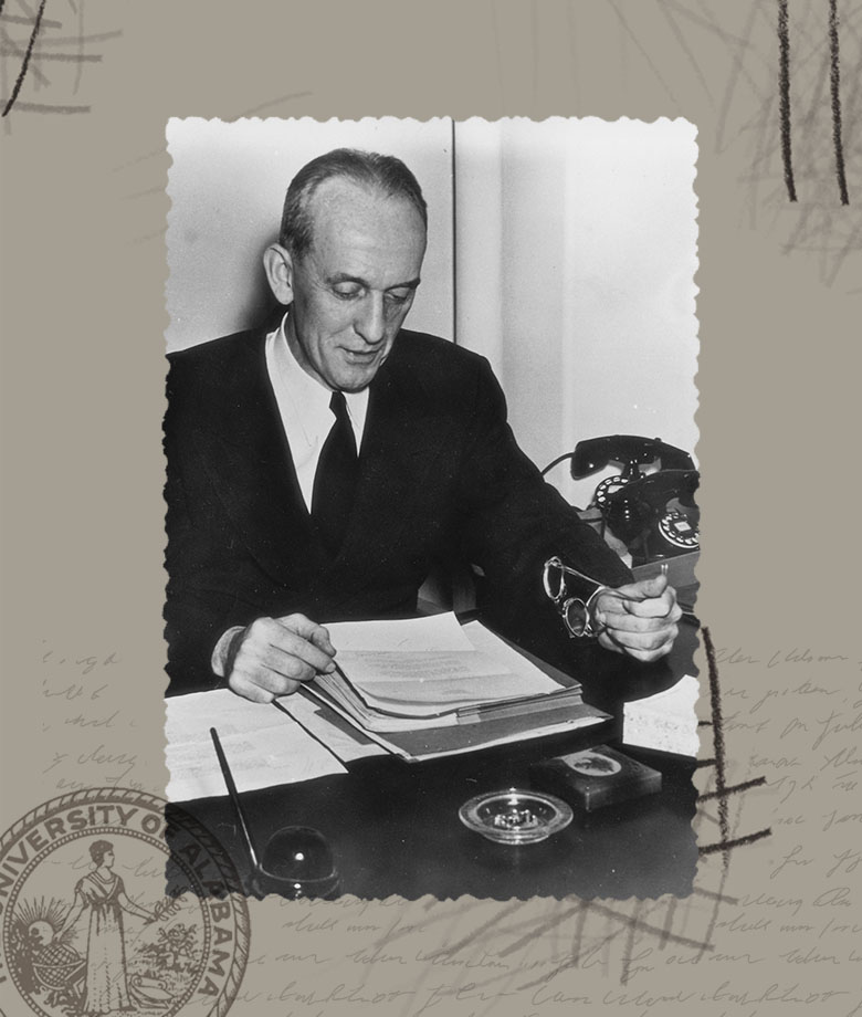 Dean Kracke reading papers at his desk.