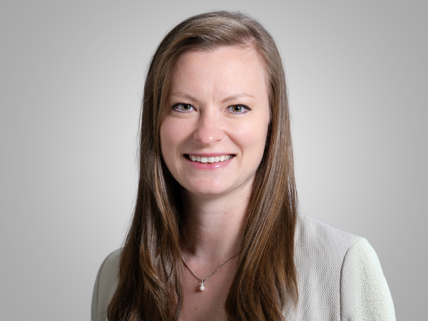 Professional woman in white blazer.