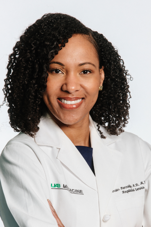 Kierstin Kennedy, M.D., MSHA, stands in front of a white background.
