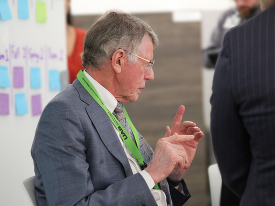 Dr. Heersink speaking with his hands raised in the biomedical innovation lab