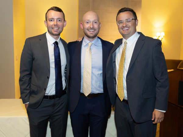 Zach Burns, M.D., Pharm.D., Alex Nocera, M.D., and Corbin Norton, M.D., pose at graduation
