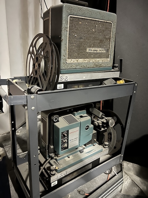 A reel-to-reel projector on a cart.