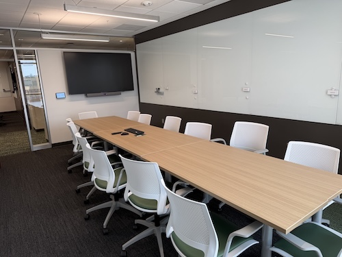Conference table with large white board on wall.