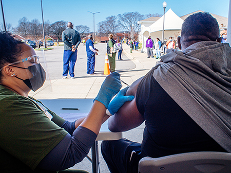 A patient in a vehicle is driving forward after their 15-minute observation period after receiving a COVID-19 vaccination as UAB and the City of Hoover open up a COVID-19 Vaccination Site at the Hoover Met Complex on February 2, 2021. 