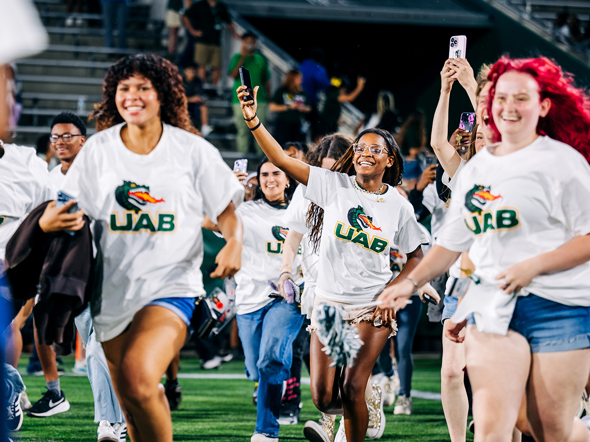UAB freshmen run across the field at Protective Stadium.
