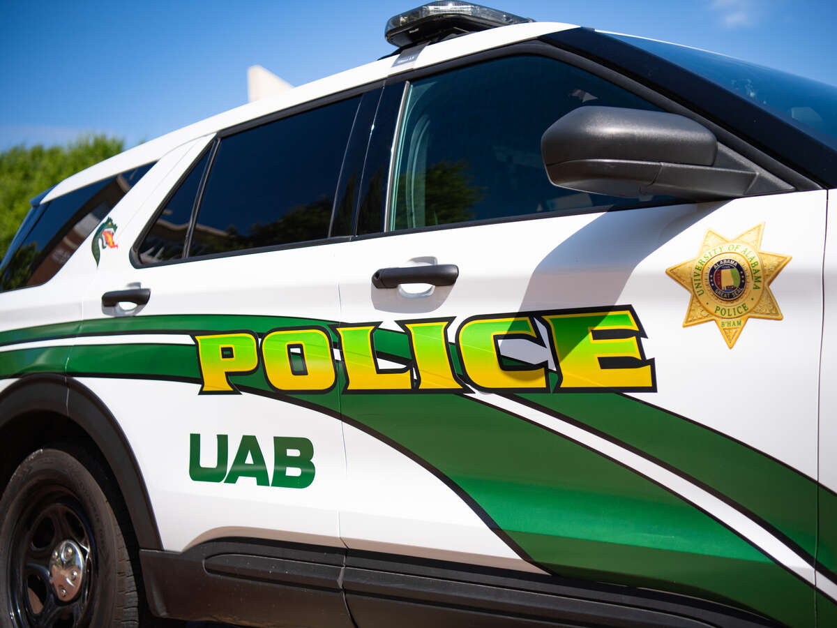 From side, close-up detail of a parked UAB Police branded vehicle showing the words 