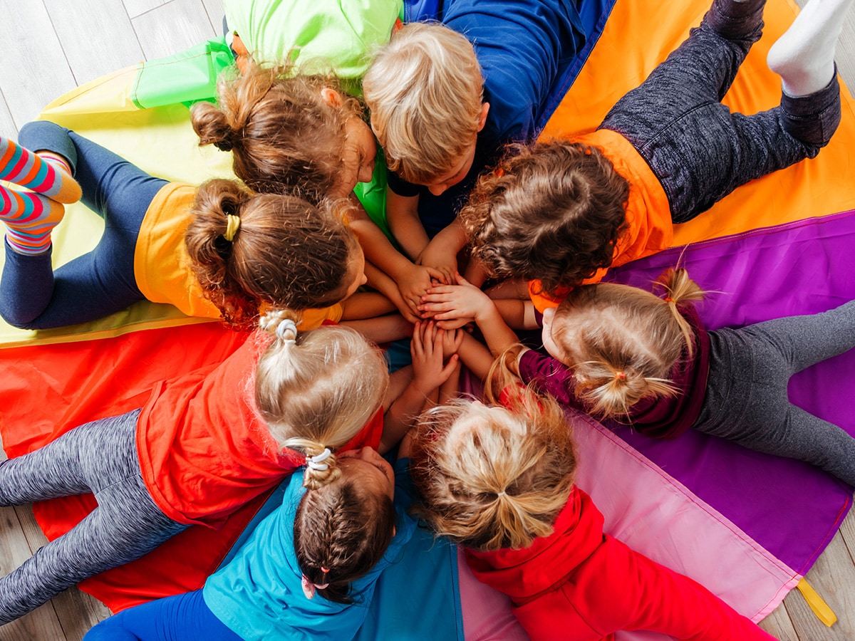 group of children in daycare playing a game on the floor