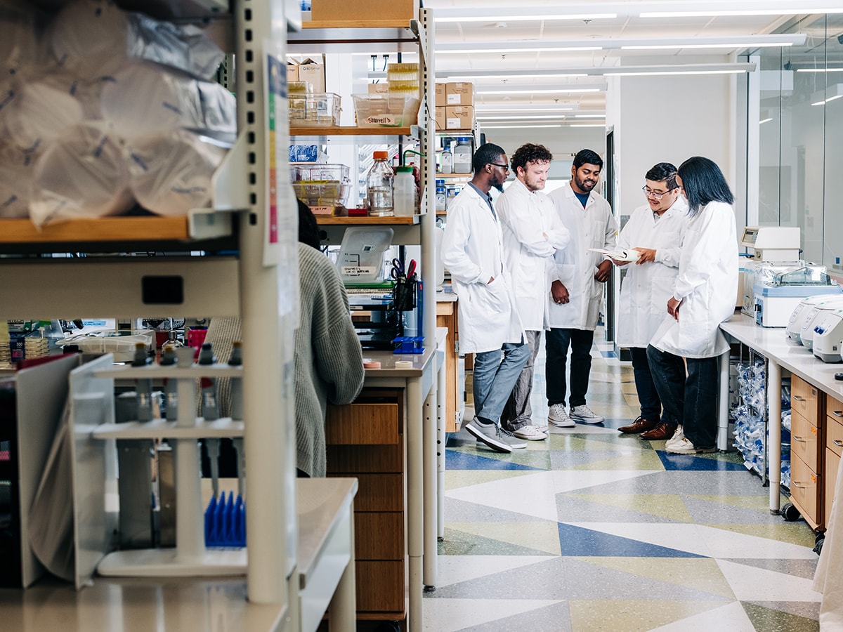 Researchers gathered for a lab meeting in a UAB research lab