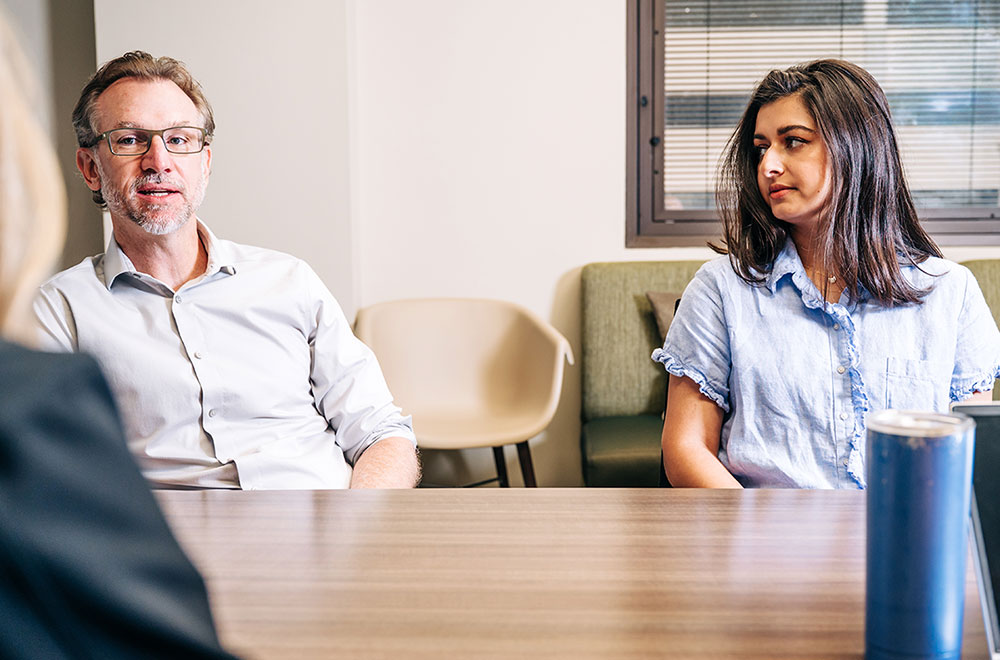 Nathaniel Erdmann, M.D., Ph.D., comments on a patient case while colleague Aditi Jani, M.D., looks on