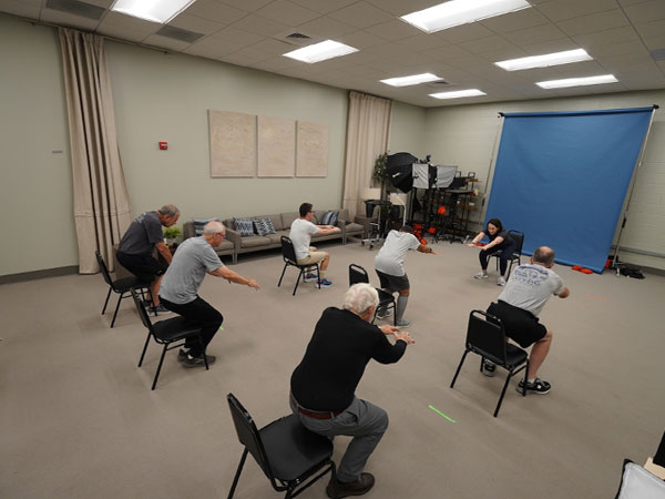 Vanessa Kaczmarek instructs the class to strike a specific stretch.