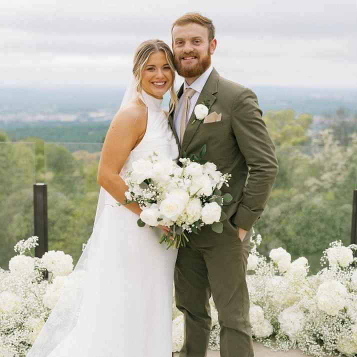 Bumpas poses with husband on wedding day.
