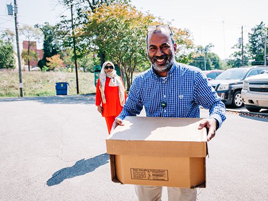 Muhammad Saleem, Birmingham Islamic Society treasurer, helps unload boxes of halal chicken. Photography: Andrea Mabry